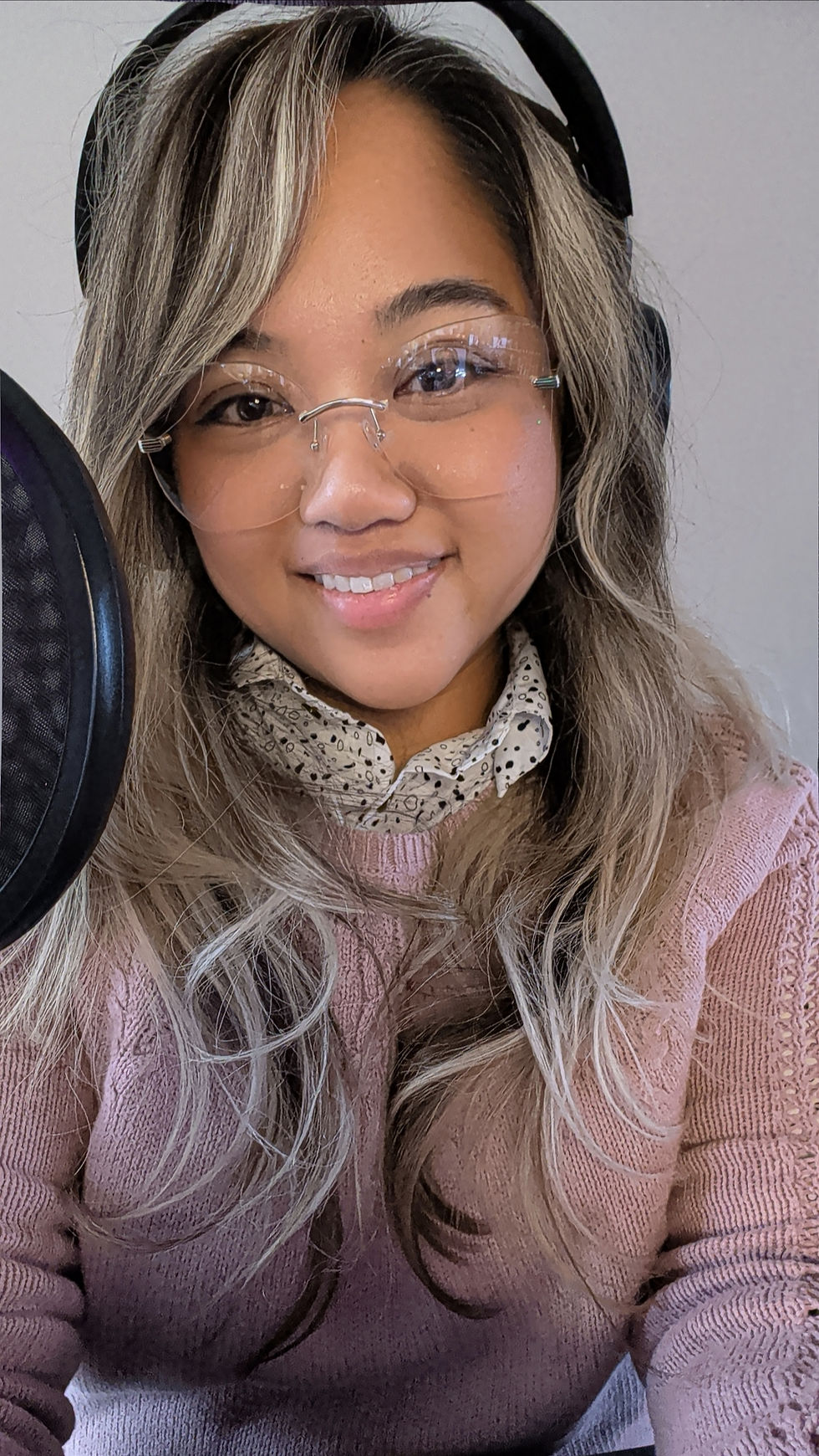 Fran, known as TheLadyWithBread, smiling while wearing glasses and a headset microphone, photographed indoors during her DreamHack Atlanta media experience.